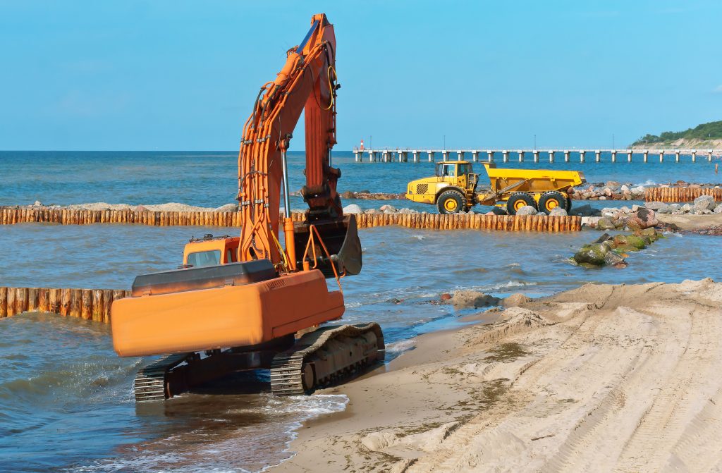 Construction of breakwaters in the sea. Construction equipment and machinery